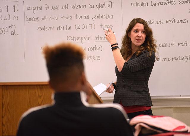 Female professor at a white board